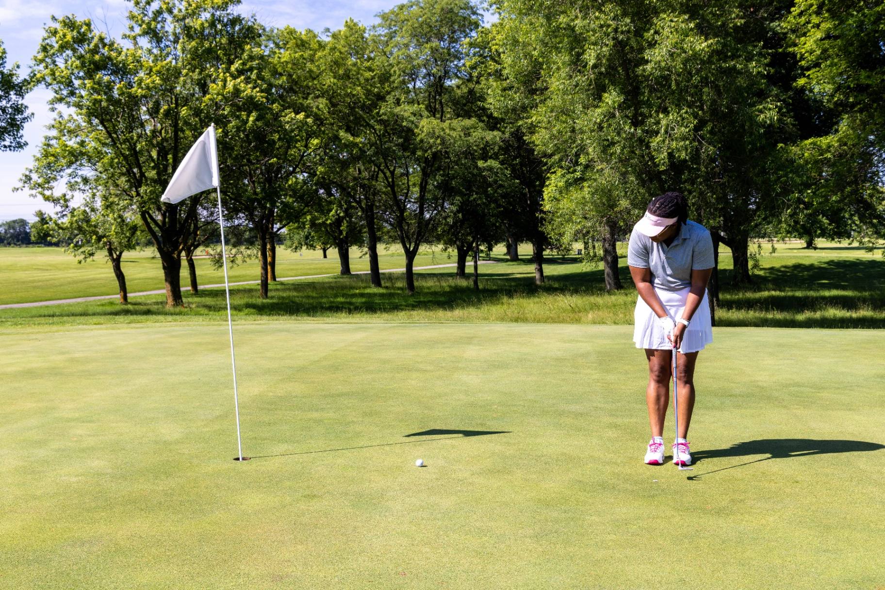 Golfer lining up a putt on the green